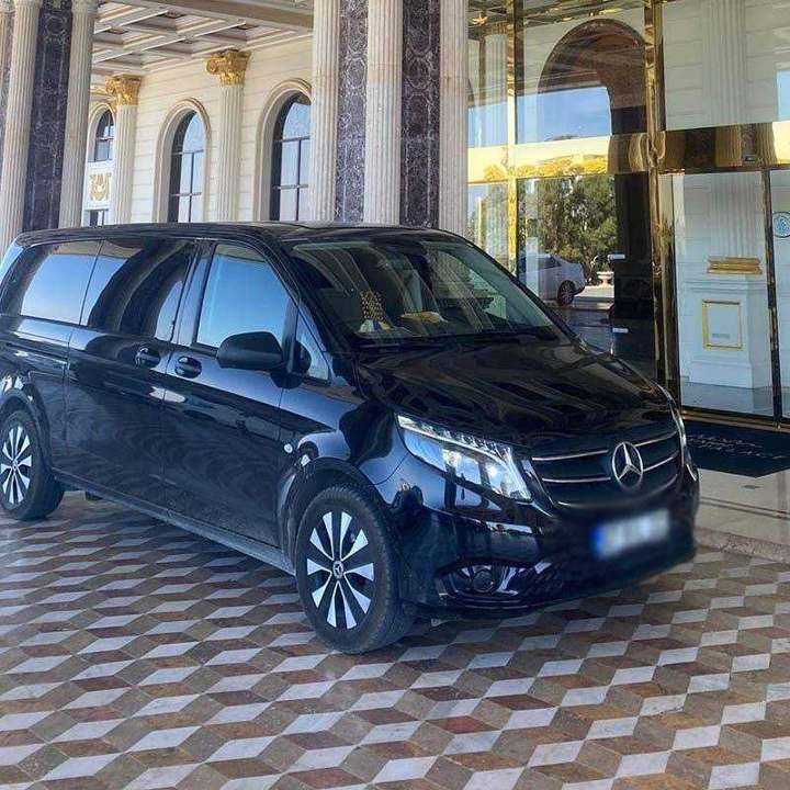 Black Mercedes van at a hotel entrance